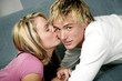 Woman giving her boyfriend a peck on the cheek