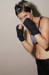 Muscular woman practising boxing 