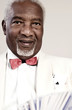 Photo: Old man in formal wear holding playing cards Old man in formal wear holding playing cards