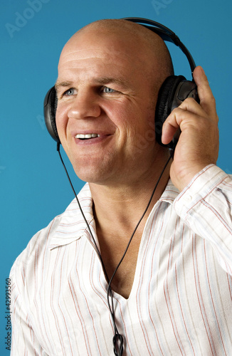 Photo: Man listening to music on his headphone Man listening to music on his headphone