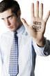 Businessman with the word 'Need Sleep' written on his palm
