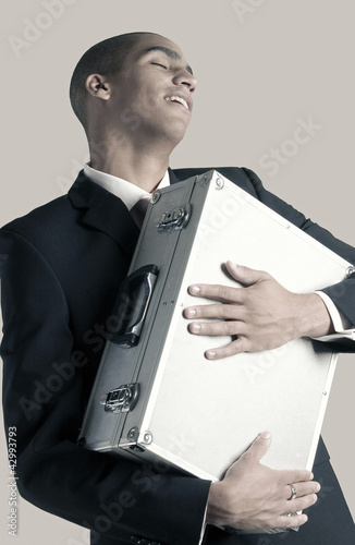 Photo: Businessman hugging his briefcase Businessman hugging his briefcase