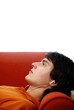 Man lying on the couch listening to music on the earphones