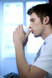 Man thinking while drinking coffee