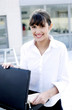Businesswoman taking out documents from the briefcase