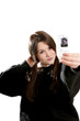 Girl taking her own picture with a camera cell phone