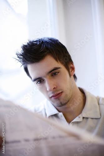 Photo: Man reading newspaper Man reading newspaper