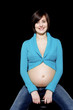 Pregnant woman smiling at the camera
