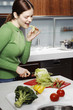 Woman cutting vegetables in the kitchen