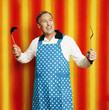 Man in apron holding a ladle and a spatula