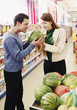 Couple choosing water-melon in the supermarket