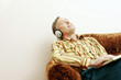 Photo: Man listening to music while reading book Man listening to music while reading book