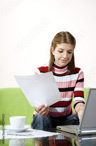 Photo: Girl doing assignment on the laptop Girl doing assignment on the laptop