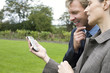 Businessman and woman looking at handheld device