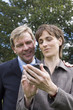 Businessman and woman looking at handheld device
