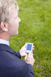 Businessman holding a handheld device