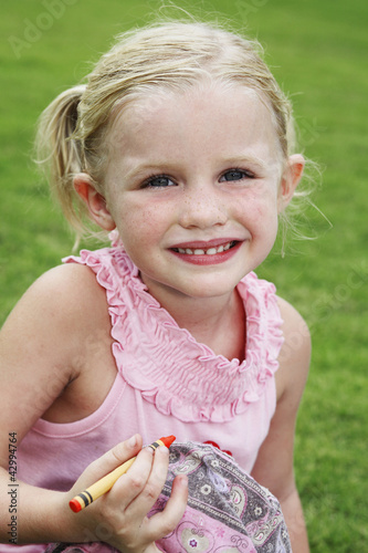 Photo: Girl holding a crayon Girl holding a crayon