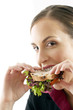 Businesswoman biting into a sandwich