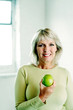 Woman holding a green apple