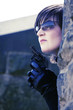 Photo: Woman with pistol hiding behind a tree Woman with pistol hiding behind a tree