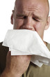 Crying man blowing his nose