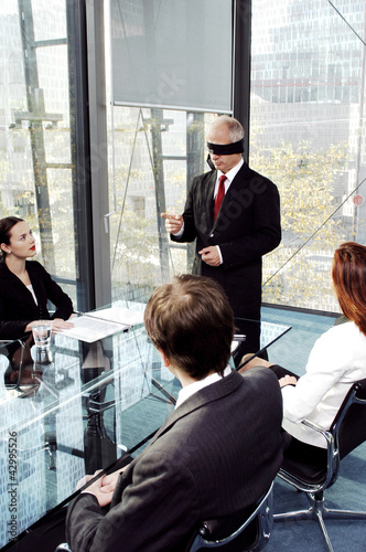 Photo: Blindfolded businessman talking in the conference room Blindfolded businessman talking in the conference room