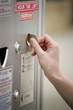 Inserting a coin into the parking meter