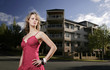 A teenage girl posing in front of the apartment