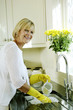 Senior woman washing the dishes at the basin