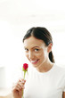 Young woman smelling rose