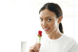 Young woman smelling rose
