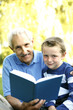 Senior man reading for his grandson
