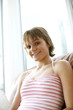 Teenage girl sitting on the couch smiling