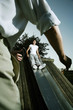 Teenage girl sliding down a slide with her father waiting at the bottom