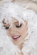 Young woman with white feathers posing for the camera
