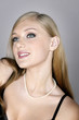 Young woman in black smiling while looking up
