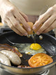 Frying eggs, bacon and sausages