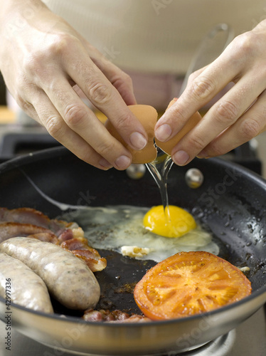 Photo: Frying eggs, bacon and sausages Frying eggs, bacon and sausages