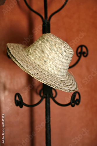 Photo: Hat hanging on a coat rack Hat hanging on a coat rack