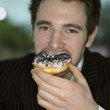 Guy eating doughnut