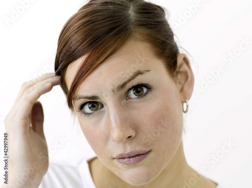 Photo: Woman adjusting her hair Woman adjusting her hair