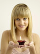 Pretty girl holding a lighted aromatherapy candle
