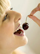 Pretty girl eating a cherry