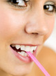 Woman biting a straw