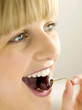 Pretty girl eating a cherry