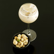 Cream liqueur with ice and bowl of mixed nuts