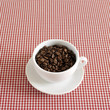 Fresh espresso coffee beans in a cappuccino cup
