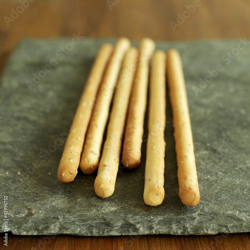 Photo: Italian sesame breadsticks on slate Italian sesame breadsticks on slate