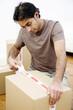 Man sealing up boxes