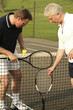 Men with tennis racquet and ball